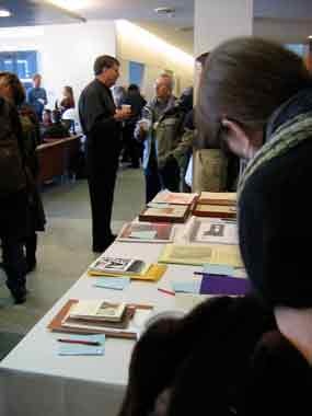 A photo of people looking at auction items at an auction