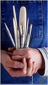 A closeup of hands holding book making tools