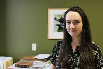 Isabella Myers poses in the UI Libraries Conservation Lab.