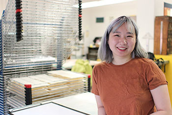 Cat Liu poses in the UICB letterpress studio.