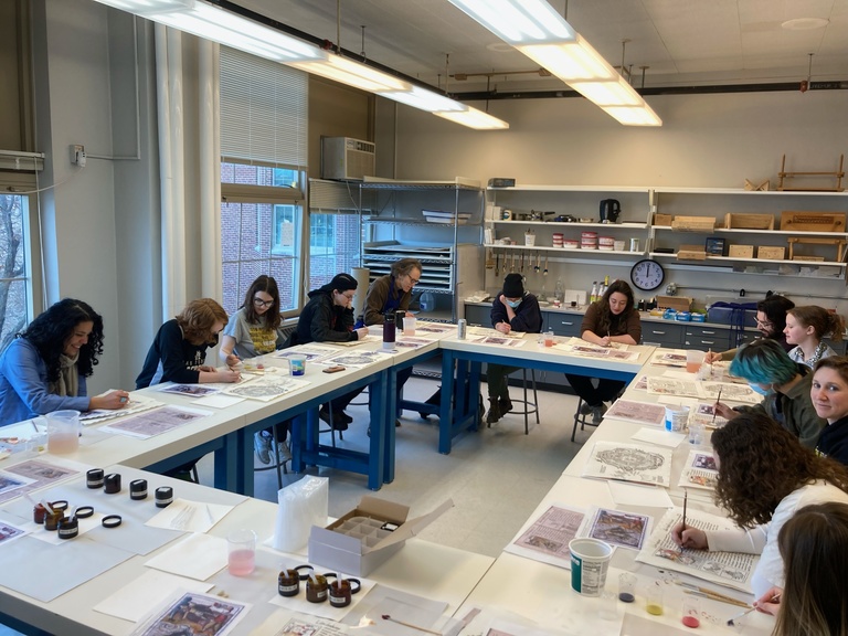 A group of people in classroom painting