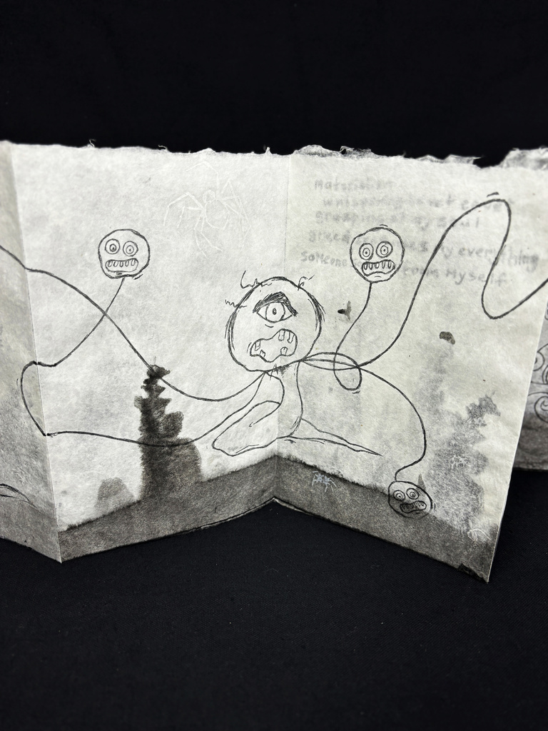 Close up of accordion book with illustrations