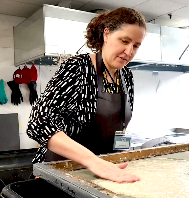 Woman working with paper pulp