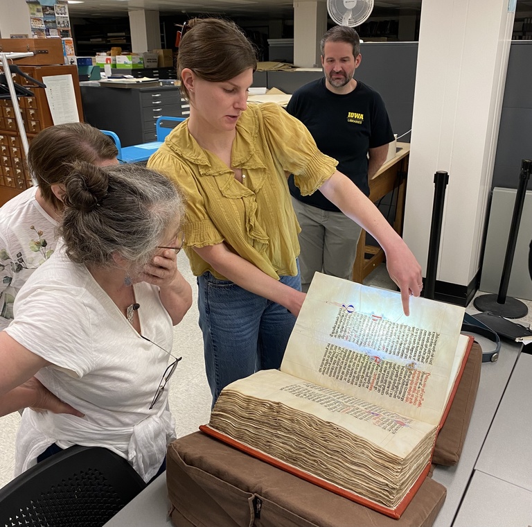 woman pointing at large book