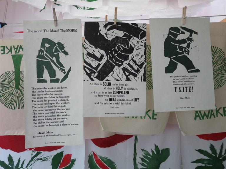 Letterpress prints with image and text hanging on clotheslines to dry.