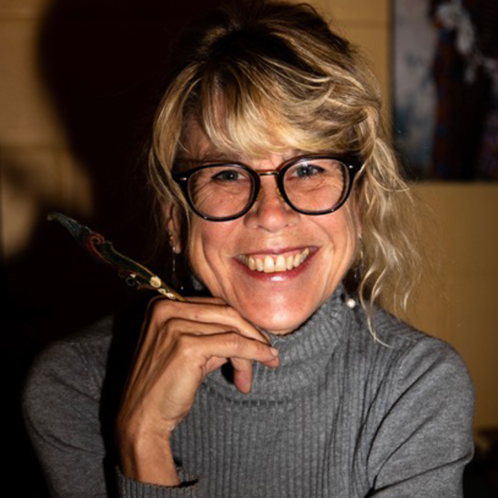 A photo of a person, Cheryl Jacobsen, smiling.