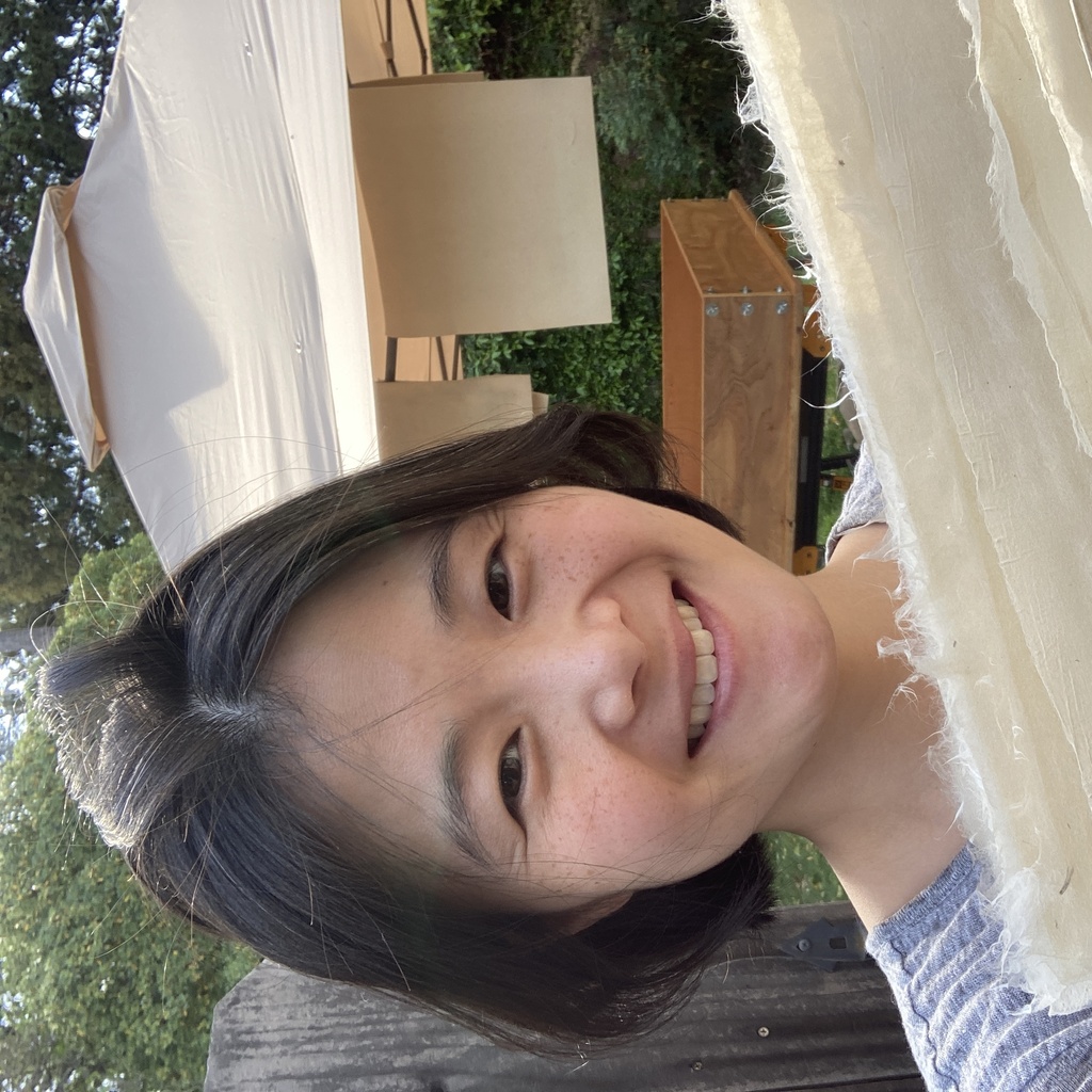 a person holding a stack of hanji (paper)