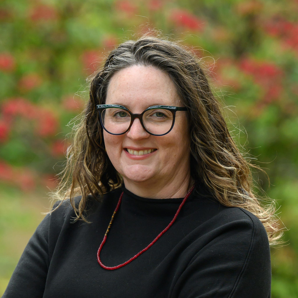 a person with glasses standing outside